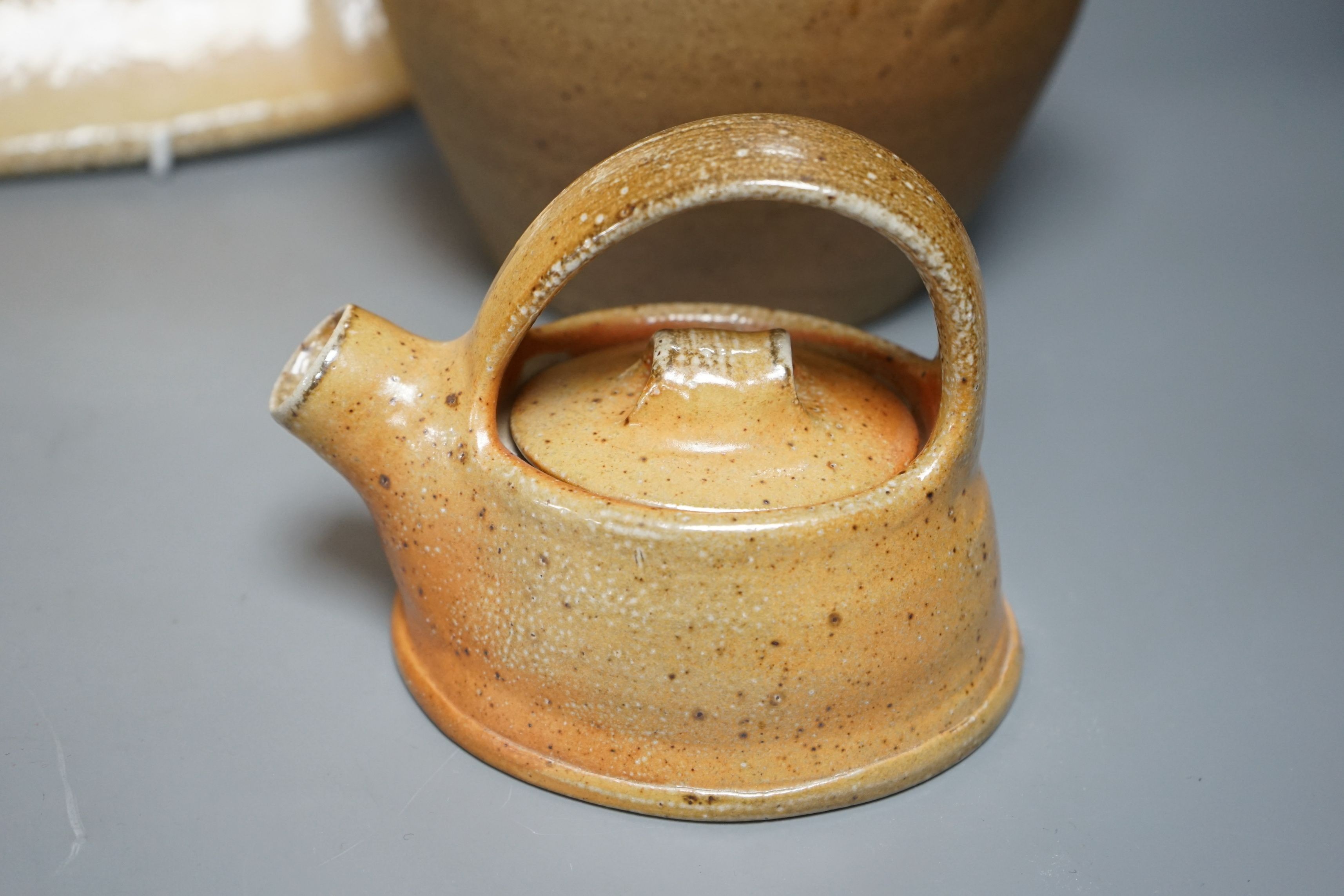 British studio pottery; a group to include a Micki Schloessingk (b.1949) salt glaze teapot and cover, together with other similar items and other studio pottery wares, largest 39cm wide, (5)